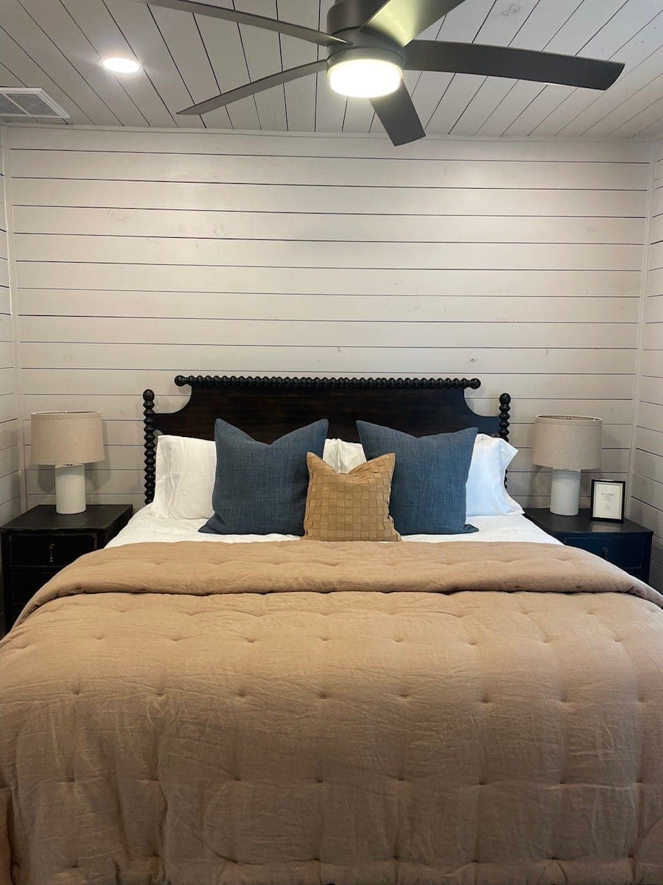 Shiplap on a bedroom wall and ceiling showing the finished reveal