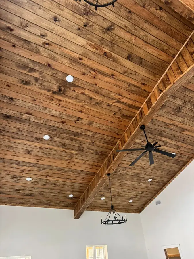 Stained pine tongue and groove ceiling in a residential great room